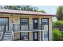 Exterior of a lovely condo building, highlighting the private balcony and well-lit entrance at 2400 Winding Creek Blvd # Bldg18A210, Clearwater, FL 33761