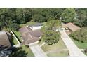Aerial view of a single Gathering home with a screened-in pool and spacious yard at 2532 Sweetgum W Way, Clearwater, FL 33761