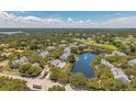 An aerial shot shows a community with a pool, pond, and well-maintained landscaping at 3301 Haviland Ct # 301, Palm Harbor, FL 34684