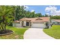 Beautiful single-story home with a well-manicured lawn and an attached two-car garage at 3509 Country Creek Ln, Valrico, FL 33596