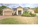 Charming single Gathering home featuring a neutral paint scheme, well-manicured lawn, and mature landscaping at 3603 Arbor Chase Dr, Palm Harbor, FL 34683
