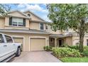 Inviting two-story home with a brick-paved driveway, two-car garage, and a welcoming front entrance at 3918 Silverlake Way, Wesley Chapel, FL 33544