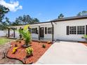 Charming single-story home with a covered front porch and fresh landscaping at 4401 S Trask St, Tampa, FL 33611