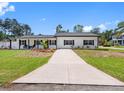 Charming single-story home with a well-manicured lawn, black accents and a quaint front porch at 4401 S Trask St, Tampa, FL 33611