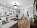 Spacious living room featuring a modern chandelier, recessed lighting, and wood-look flooring at 4401 S Trask St, Tampa, FL 33611