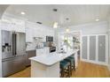 Modern kitchen with white cabinets, stainless steel appliances, and an island with seating at 4711 12Th N St, St Petersburg, FL 33703
