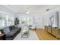 Bright living room with hardwood floors, a modern rug and a comfortable grey couch at 4711 12Th N St, St Petersburg, FL 33703