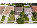 Aerial view of home showing roof, lawn, and proximity to nearby neighborhood at 4735 Red Pine Way, Wesley Chapel, FL 33545