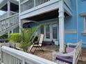 Private patio with outdoor seating, a brick floor, and access to the upper-level balcony at 4985 Cobia Se Dr # A, St Petersburg, FL 33705