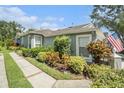 Charming home with a well-manicured lawn and colorful landscaping, showcasing its inviting curb appeal at 6041 Sandhill Ridge Dr, Lithia, FL 33547