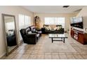 Spacious living room featuring tile floors, comfortable seating, and ample natural light at 637 Kensington Lake Cir, Brandon, FL 33511