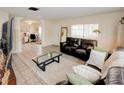 Open living room with tile floors, large windows, and a seamless transition to the dining area at 637 Kensington Lake Cir, Brandon, FL 33511