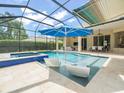 Screened in pool area with clear blue swimming pool, in-ground spa, and comfortable outdoor seating at 6905 Arabian Rd, Odessa, FL 33556