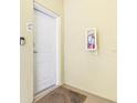 Condo hallway featuring a secure white entry door, apartment number, and a wall-mounted fire extinguisher at 706 Bayway Blvd # 503, Clearwater, FL 33767