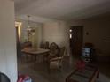 Unfurnished living room featuring dated decor, paneled walls, and natural lighting from front windows at 729 41St St, Sarasota, FL 34234