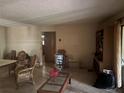 Bright living room showcasing dated decor, paneled walls, and natural lighting from sliding glass doors at 729 41St St, Sarasota, FL 34234