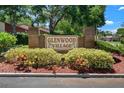 Welcoming entrance sign for Glenwood Village, surrounded by lush landscaping at 7433 Greystone Dr # 7433, Hudson, FL 34667