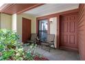 Inviting covered porch with seating area, providing a welcoming entrance to the residence at 7433 Greystone Dr # 7433, Hudson, FL 34667