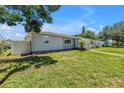 Side view of a cozy single-story home with a lush green lawn at 774 40Th Ne Ave, St Petersburg, FL 33703