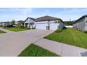The home boasts a three-car garage and well-maintained landscaping at 8840 Mugnai St, Riverview, FL 33578