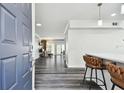 An open foyer with dark floors leads into the living spaces of this home, with bar stool seating for the kitchen at 4304 Harbor House Dr, Tampa, FL 33615