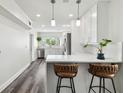 A bright, recently remodeled kitchen features white cabinets, stainless appliances, and bar stool seating at 4304 Harbor House Dr, Tampa, FL 33615