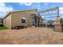 A spacious backyard patio area offers ample room for outdoor entertaining in a screened-in enclosure at 10327 Meadow Crossing Dr, Tampa, FL 33647