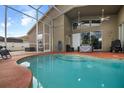 Relaxing screened-in outdoor pool area, perfect for enjoying Florida's warm weather with covered lanai at 10327 Meadow Crossing Dr, Tampa, FL 33647