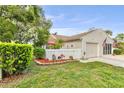 Attractive single Gathering home with front yard, flower garden, and attached garage at 12529 Knollbrook Ln, Hudson, FL 34669