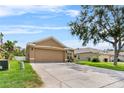 Well-maintained single-story home with a two-car garage, and a spacious driveway at 12631 Chenwood Ave, Hudson, FL 34669
