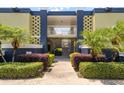 Secured building entrance with mature landscaping and tiled accents at 1301 S Howard Ave # A9, Tampa, FL 33606