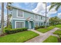 Charming townhouse showcasing lush green lawn and manicured shrubs, painted in refreshing two-tone color at 1312 Kelridge Pl, Brandon, FL 33511