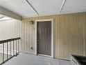 Close-up of unit 202 showcasing a front door, exterior light fixture, and building color scheme at 13285 Arbor Pointe Cir # 202, Tampa, FL 33617