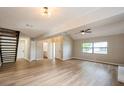 Open-concept living room featuring new floors, a modern staircase, and ample space for entertaining at 14909 Oldgate Pl, Tampa, FL 33624