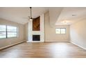 Bright living room with vaulted ceiling, fireplace, new flooring, and abundant natural light at 14909 Oldgate Pl, Tampa, FL 33624