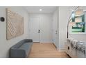 Bright entryway with hardwood floors, modern decor, and a bench for comfortable seating at 1707 Solon Ave, Dunedin, FL 34698