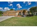 Well-maintained home featuring a manicured lawn, mature trees, and attractive landscaping in the front yard at 18168 Clearview Dr, Brooksville, FL 34604