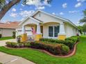 Inviting single-story home with a well-kept lawn and a charming front porch at 18203 Tivoli Ln, Lutz, FL 33558