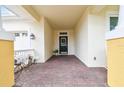 Spacious front porch with decorative brick pavers and classic white columns at 18203 Tivoli Ln, Lutz, FL 33558