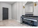 Stylish tiled entrance with a Donner piano and stool, complemented by modern lighting and wall decor at 18527 Cortes Creek Blvd, Spring Hill, FL 34610