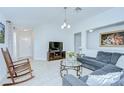 Bright living room with vaulted ceilings, neutral walls, stylish furnishings, and tile flooring at 19555 Timberbluff Dr, Land O Lakes, FL 34638