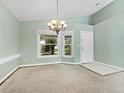 Inviting space with a charming chandelier and plenty of natural light from double windows at 2068 Diane Ave, Palm Harbor, FL 34683