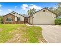 Charming single-story home featuring a 2 car garage and well-manicured front yard at 2141 Coachman Rd, Spring Hill, FL 34608