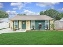 Charming home featuring a well-manicured lawn, a welcoming door, and lovely curb appeal at 3026 Cedaridge Dr, Tampa, FL 33618