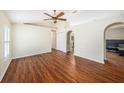 Bright, open living area with hardwood floors, vaulted ceiling and arched doorway at 3443 Fyfield Court, Land O Lakes, FL 34638