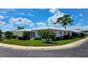 Beautiful corner lot residence featuring white siding, green shutters, and professionally maintained landscaping at 3605 100Th N Ter, Pinellas Park, FL 33782