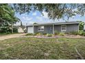 Inviting single-story home with a manicured front yard and gray exterior at 3625 Oakhurst Dr, Holiday, FL 34691