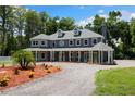 Beautifully landscaped home with covered porch and circular driveway at 3663 Berger Rd, Lutz, FL 33548
