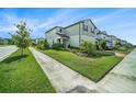 Beautifully landscaped front yard, complemented by a sidewalk at 4608 Emprise Way, Land O Lakes, FL 34638