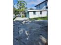 Spacious backyard with concrete pad area, bordered by a white picket fence, offers privacy at 507 Danube Ave, Tampa, FL 33606